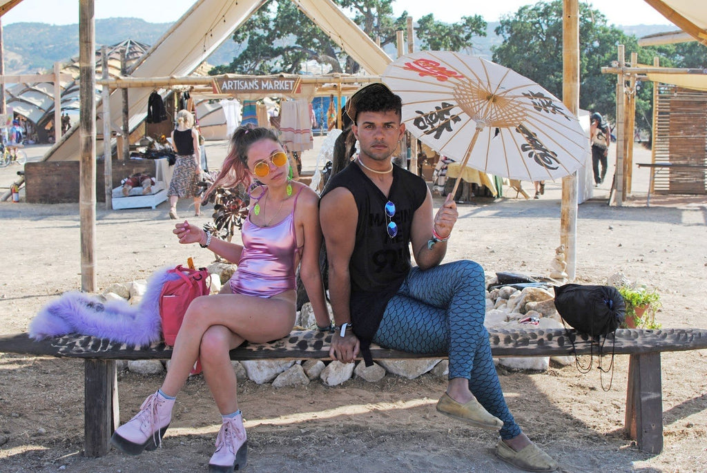 Girl in Pink Holographic Bodysuit with Neon Pink Combat Boots and Guy in Blue Mermaid Leggings during Lightning in a Bottle Music Festival